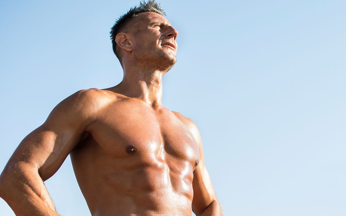 Muscular Hyperbaric Oxygen Therapy model standing confidently under blue sky.